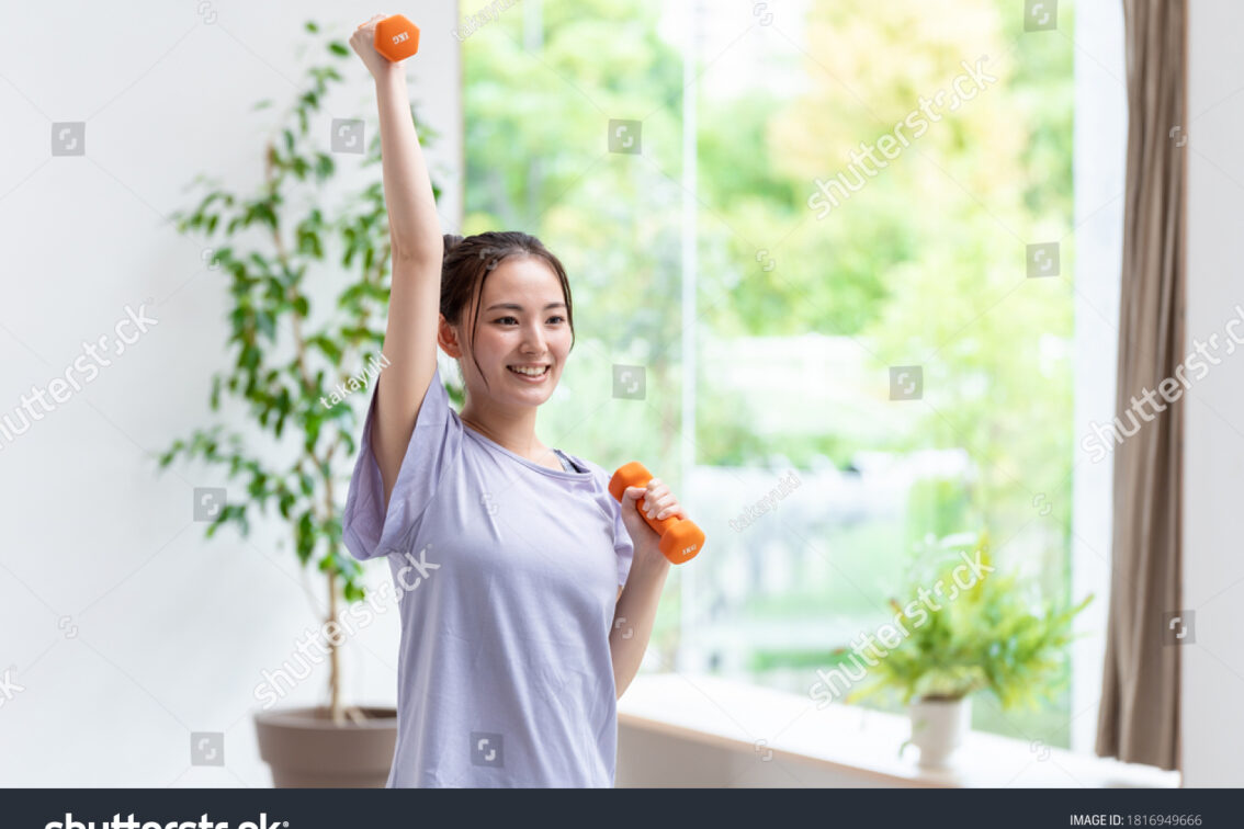 stock-photo-attractive-asian-woman-training-muscles-in-the-living-room-with-dumbbells-1816949666